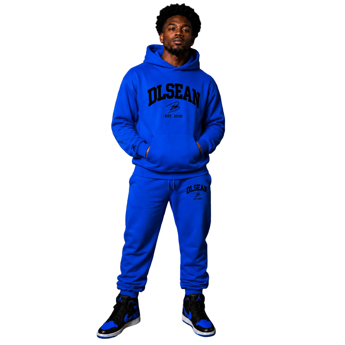 A man modeling a matching royal blue hoodie and sweatpants set with black and blue 'OLSEAN EST. 2020' graphics, shown against a plain white background.